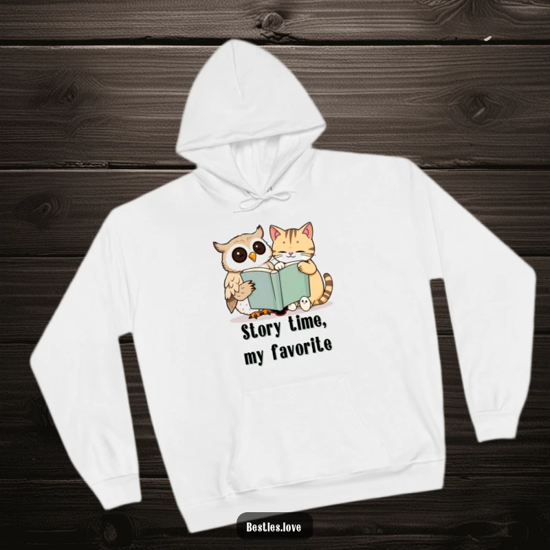 Funny hoodie with a wise owl and a sleepy cat smiling while sharing a massive book, exemplifying peaceful companionship and intellect.