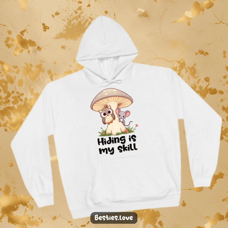 Funny hoodie with a depiction of an owl and mouse best friends playfully peeking from behind a large mushroom, perfect for warmth.