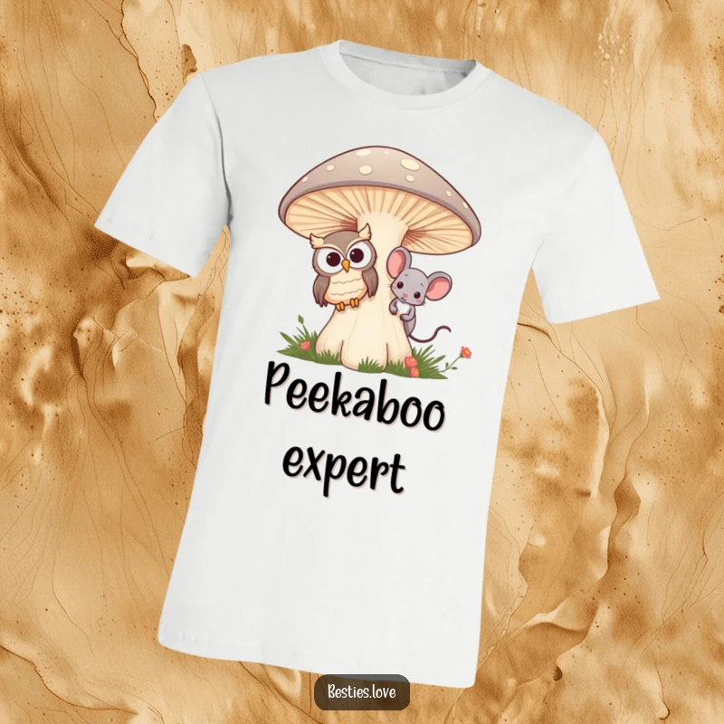 Funny t-shirt showing a friendly owl and a curious mouse peeking from behind a giant, magical mushroom, emphasizing friendship.